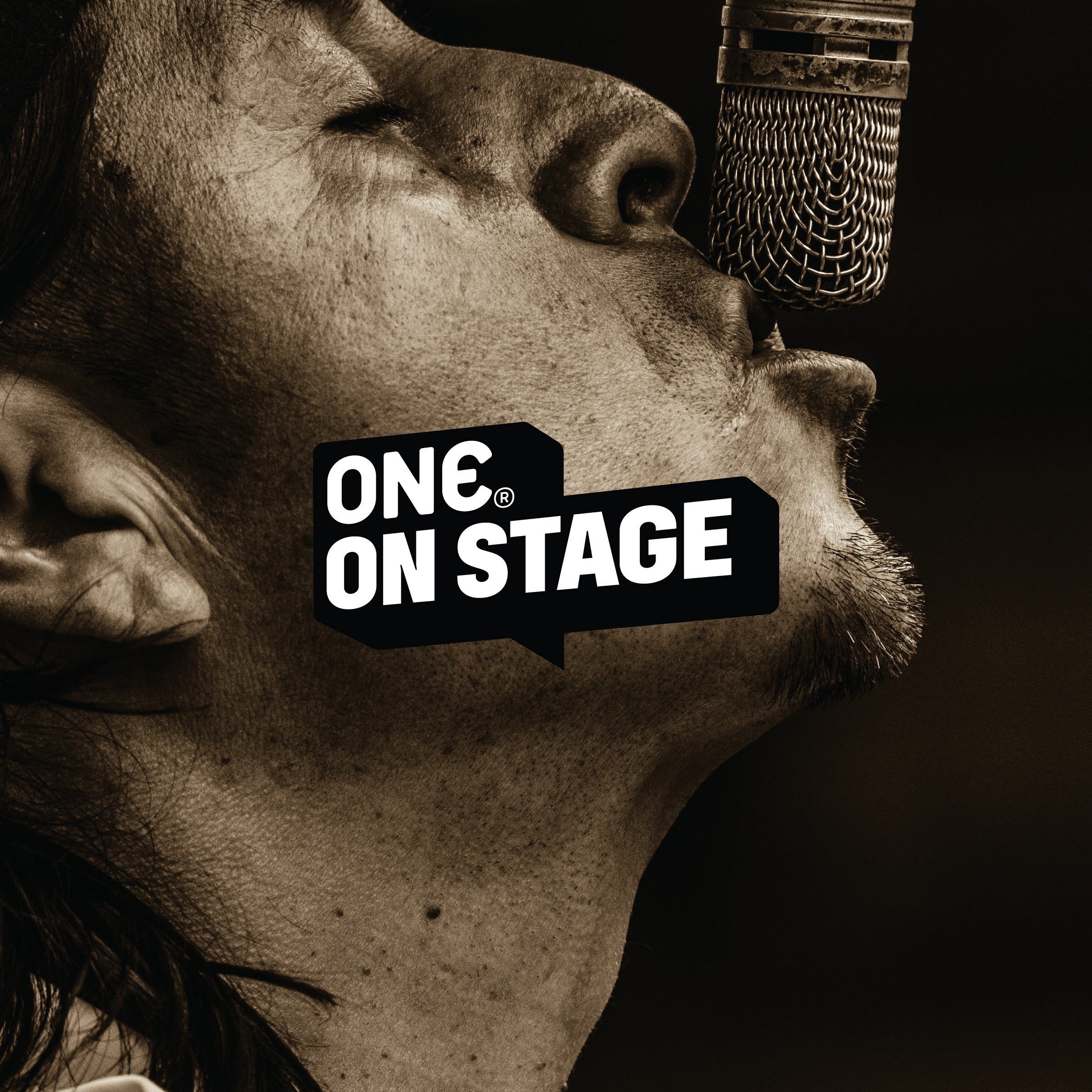 One on stage singing into mic.