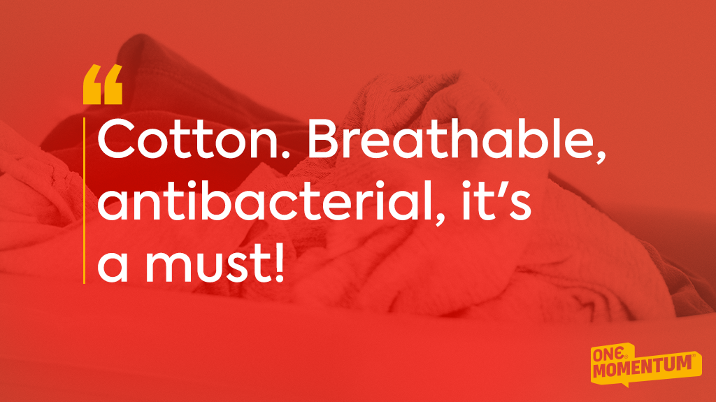 Pile of clothes with a text overlay that reads: "Cotton. Breathable, antibacterial, it's a must!"