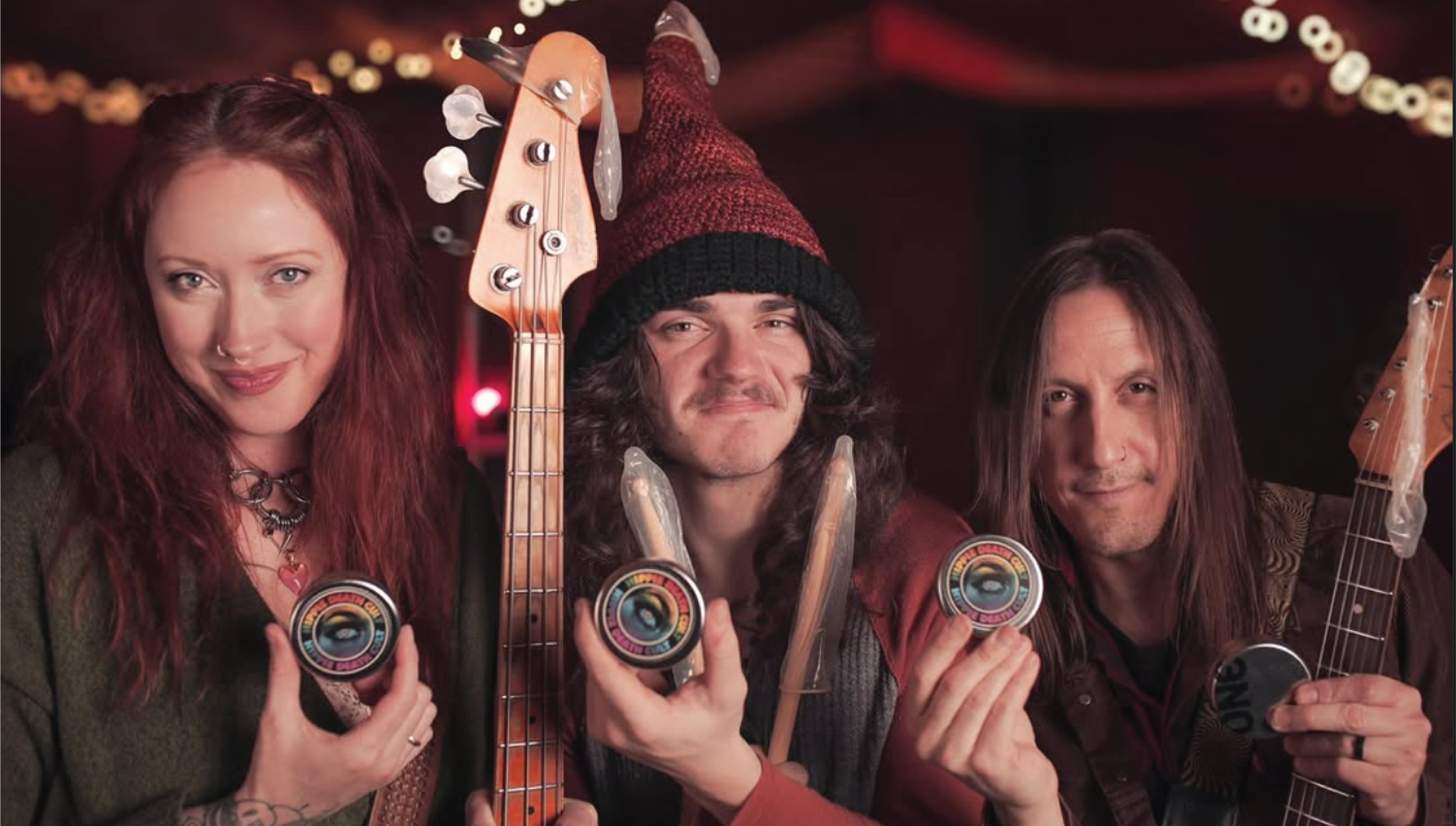 Three people hold up musical instruments and condoms in support of the ONE® on Stage program.
